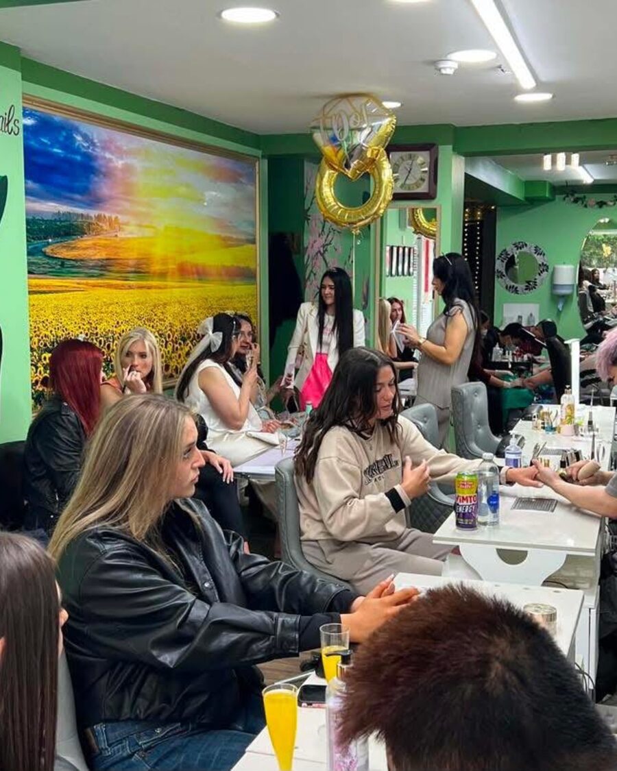 Inside UK Nails & Beauty: green walls and a row of nail stations