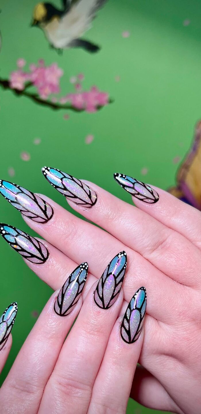 Long nails painted with blue butterfly wings
