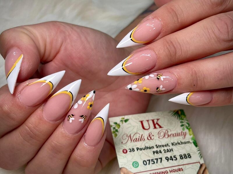 Long stiletto acrylic set with white tips and hand-painted detail
