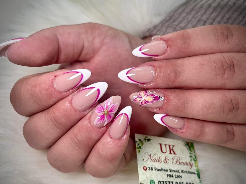 Soft pink gel manicure with white tips and painted flowers